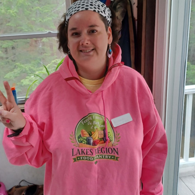 Customer wearing a pink community organization sweatshirt