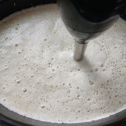 Goat milk and peppermint being blended together